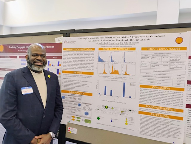 Michael Paul standing next to his research poster