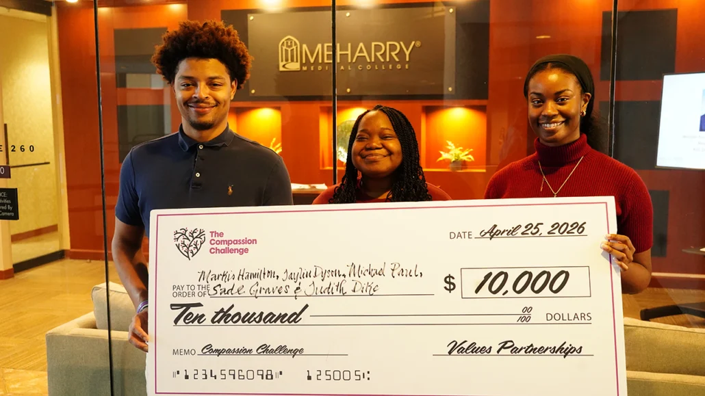 Compassion Challenge team with a large check representing their winnings