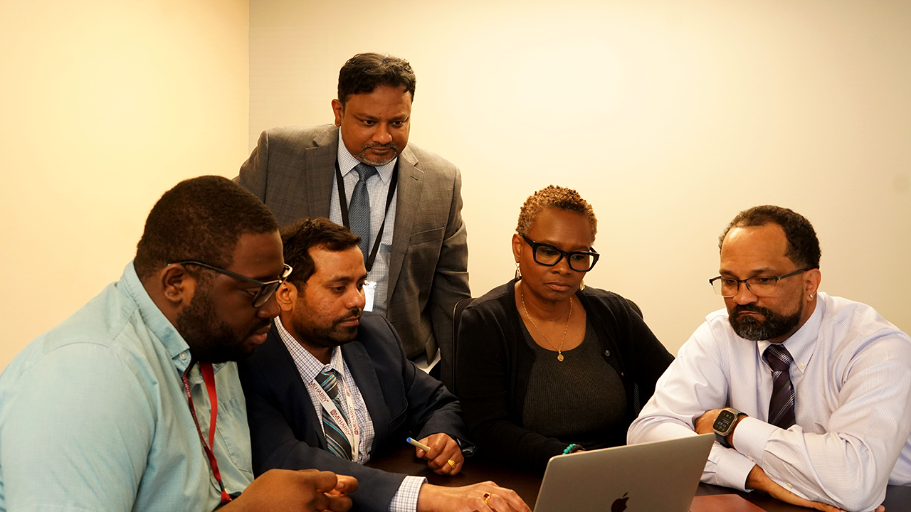 EDA staff and leadership discuss project in conference room